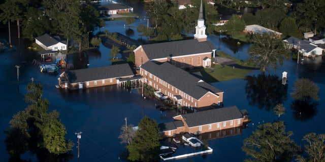 In this Monday, 九月. 17, 2018 档案照片, floodwaters surround a church and other buildings in Conway, 南卡罗来纳州, after Hurricane Florence struck the Carolinas.