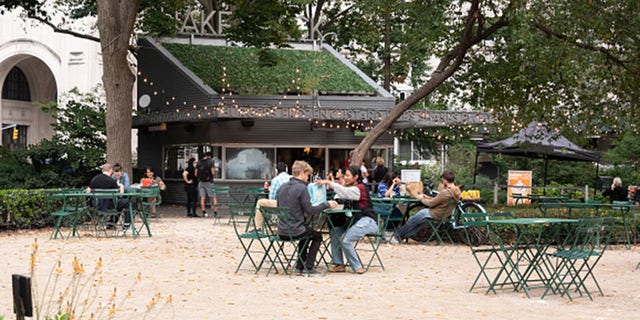 File photo - people dine outside Shake Shack in Madison Square Park in September. (Photo by Noam Galai/Getty Images)