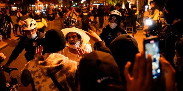 A supporter of President Trump, third from left in white hat, argues with counter-protestors after pro-Trump marches were held Saturday, Nov. 14, 2020, in Washington. (AP Photo/Julio Cortez)