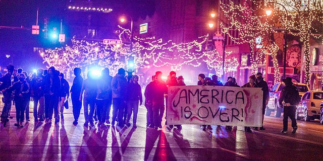 Police arrested protested who marched with fireworks to Uptown in Minneapolis, Tuesday, Nov. 3, 2020. They were cornered at Painter Park by the police. (Richard Tsong-Taatarii/Star Tribune via AP)