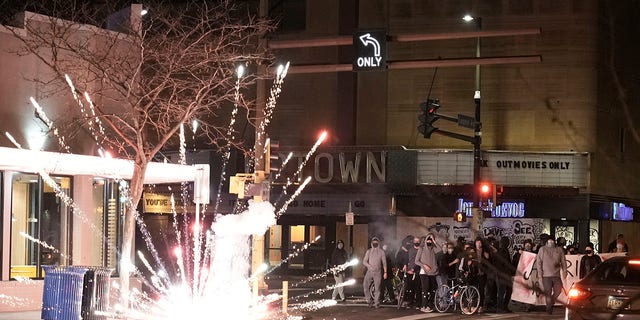 Protesters marched through Uptown Minneapolis lighting off fireworks as election numbers from across the country started to come in on Tuesday night. (Mark Vancleave/Star Tribune via AP)