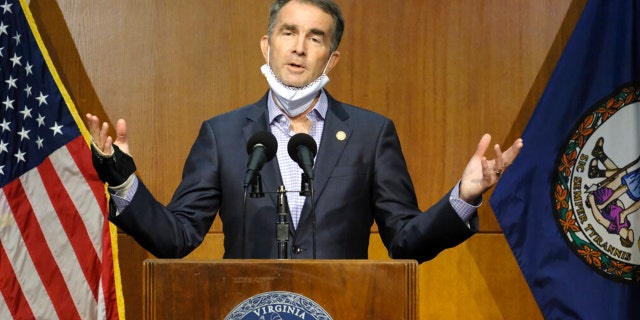 Virginia Gov. Ralph Northam answers a reporter's question dealing with the state's COVID-19 updates during a press conference at the Patrick Henry Building in Richmond, Va., Tuesday, Nov. 10, 2020. (Bob Brown/Richmond Times-Dispatch via AP)