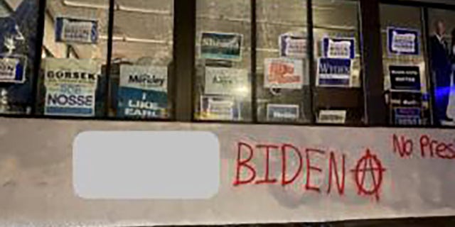 A group spray-painted an anarchy symbol and messages like "F--- Biden" and "no presidents" on the Multnomah County Democrats campaign office in Portland Sunday. (Portland Police Bureau)