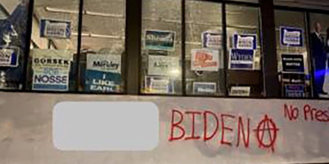 A group spray-painted an anarchy symbol and messages like "F--- Biden" and "no presidents" on the Multnomah County Democrats campaign office in Portland Sunday. (Portland Police Bureau)