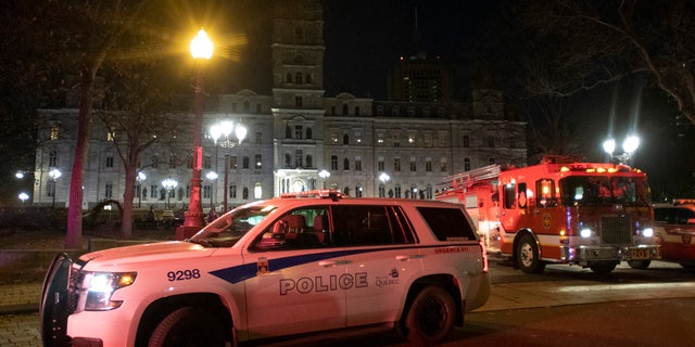 Police cars block the front of the National Assembly early Sunday, Nov. 1, 2020 in Quebec City, Canada.