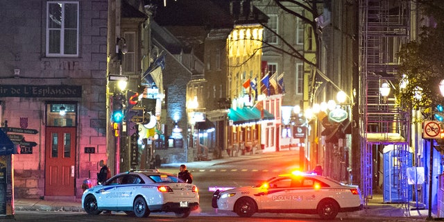 Police cars block the Saint-Louis Street near the Chateau Frontenac early Sunday, Nov. 1, 2020 in Quebec City, Canada.