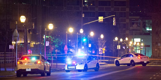 Police cars block the Quai Saint-Andre sweet where they arrested a man in medieval disguise early Sunday, Nov. 1, 2020 in Quebec City, Canada.