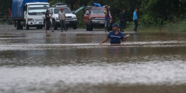A man walks through a flooded road in Okonwas, Nicaragua, Wednesday, Nov. 4, 2020.
