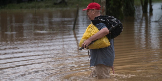 A man walks through a flooded road in Okonwas, Nicaragua, Wednesday, Nov. 4, 2020.