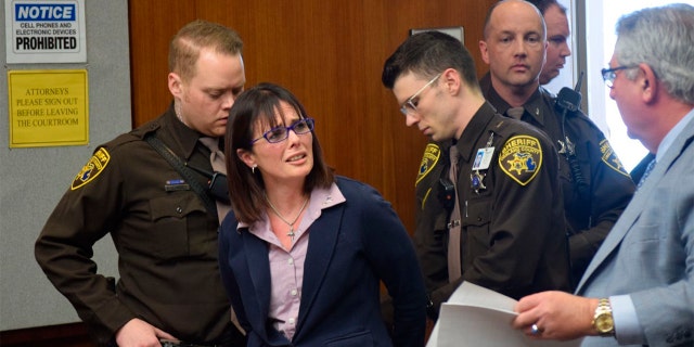 Tina Talbot gives her lawyer Jerome Sabbota a distressed look as Oakland County Sheriff's deputies put her in handcuffs after she is sentenced on April 4, 2019 in Oakland County Circuit Court. (Aileen Wingblad/The Daily Oakland Press via AP)