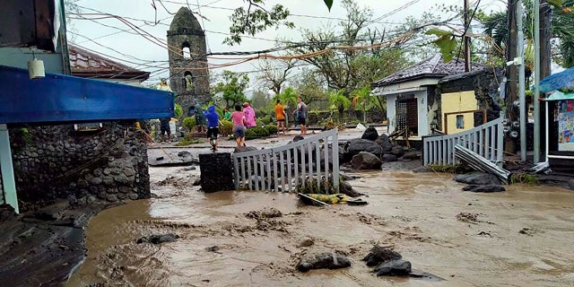 Floodwaters pass by Cagsawa ruins, a famous tourist spot in Daraga, Albay province, central Philippines as Typhoon Goni hit the area on Sunday, Nov. 1, 2020.