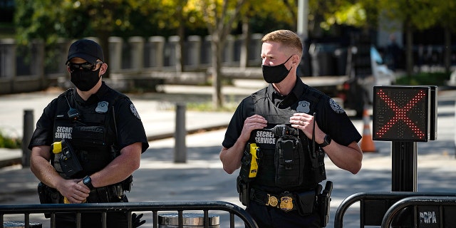 Members of the Secret Service wearing face masks stand outside the White House in Washington, D.C. on Thursday, October 8, 2020. (Getty Images)
