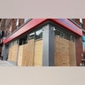 The Bank of America branch on New York City's Court Street, is one of the businesses targeted in clashes last week. It is now fully boarded up.