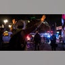 A person raises their arms as police form a perimeter during protests following the Nov. 3 presidential election in Portland, Ore., Wednesday, Nov. 4, 2020.