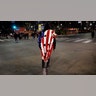 A man wears a partially burned flag during a protest after the Nov. 3 elections, Wednesday, Nov. 4, 2020, in Los Angeles.