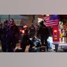 Emergency crews attend to an injured man detained by police during a protest after the Nov. 3 elections in front of the east precinct station, Wednesday, Nov. 4, 2020, in Seattle.