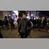 A man walks in front of police officers during protests in Portland, Ore., Wednesday, Nov. 4, 2020, following Tuesday's election.