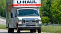 "Eastern Tennessee, USA - May 5, 2011: A U-Haul rental moving van on a Ford chasis travels down Interstate Highway I-40 westbound between Knoxville and Nashville, Tennessee.  U-Haul is one of the largest self-moving vehicle rental companies on the market."