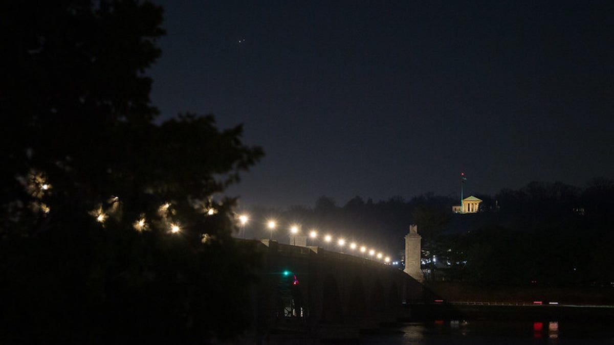 Jupiter, left, and Saturn, right, are seen during the "great conjunction" where the two planets appear a tenth of a degree apart from one another, Monday, Dec. 21, 2020, from Washington, DC. Photo Credit: (NASA/Aubrey Gemignani)