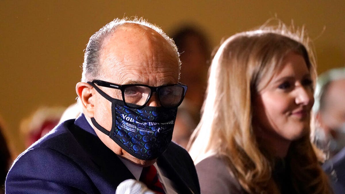 Former Mayor of New York Rudy Giuliani, a lawyer for President Donald Trump, wears a face mask to protect against COVID-19 after speaking at a hearing of the Pennsylvania State Senate Majority Policy Committee, Wednesday, Nov. 25, 2020, in Gettysburg, Pa. (AP Photo/Julio Cortez)