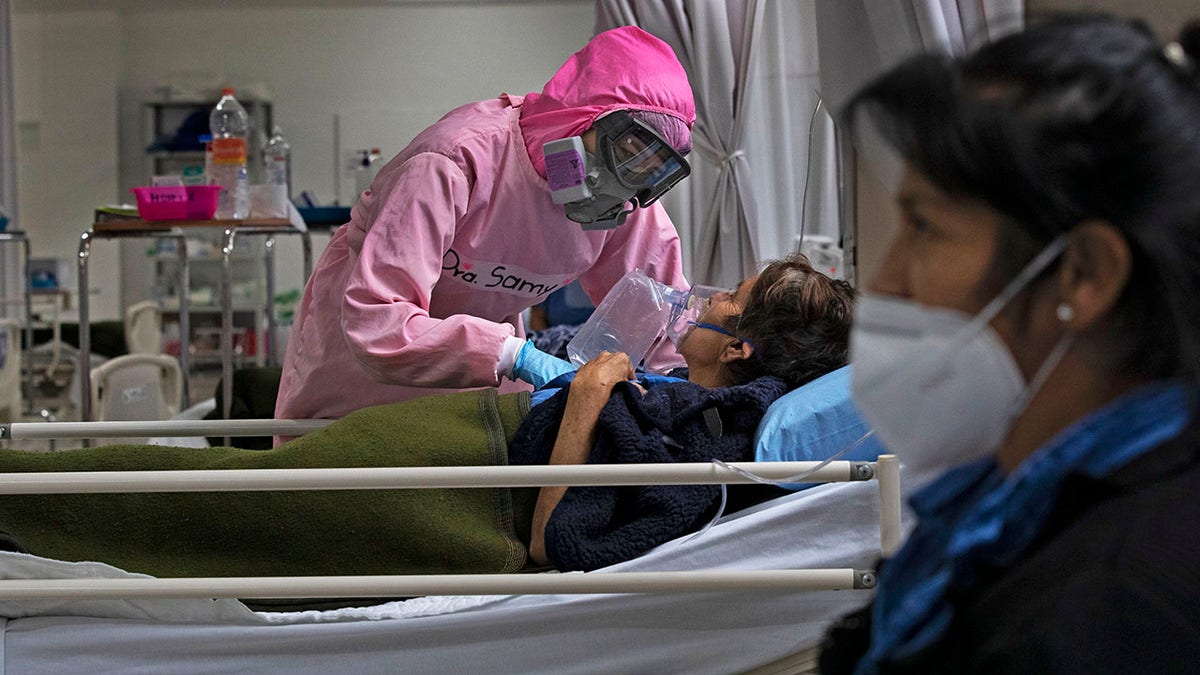 A health worker looks after patients at a military hospital set up for COVID-19 patients in Mexico City, Monday, Nov. 30, 2020. (AP Photo/Marco Ugarte)