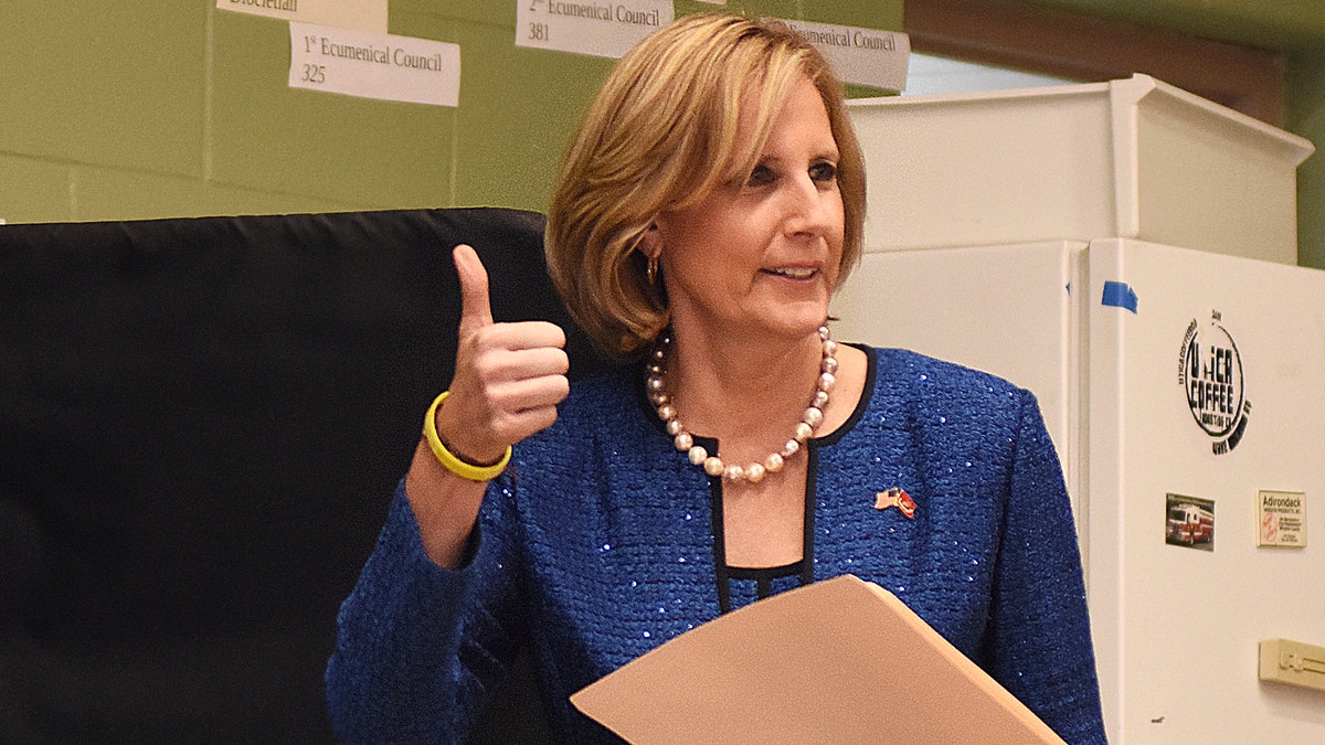 Republican Congresswoman Claudia Tenney signals she successfully cast her ballot after voting at St. George's Church in New Hartford, N.Y. (AP Photo/Heather Ainsworth, File)