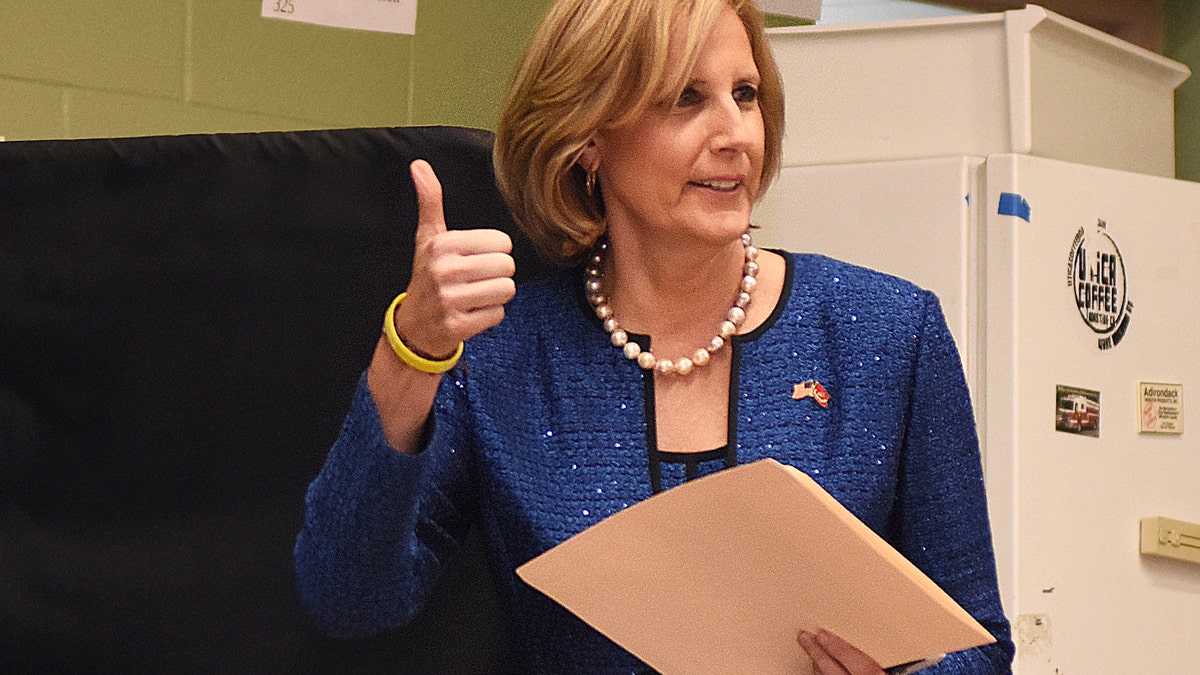 Republican Congresswoman Claudia Tenney signals she successfully cast her ballot after voting at St. George's Church in New Hartford, N.Y., on Nov. 6, 2018. (AP Photo/Heather Ainsworth, File)