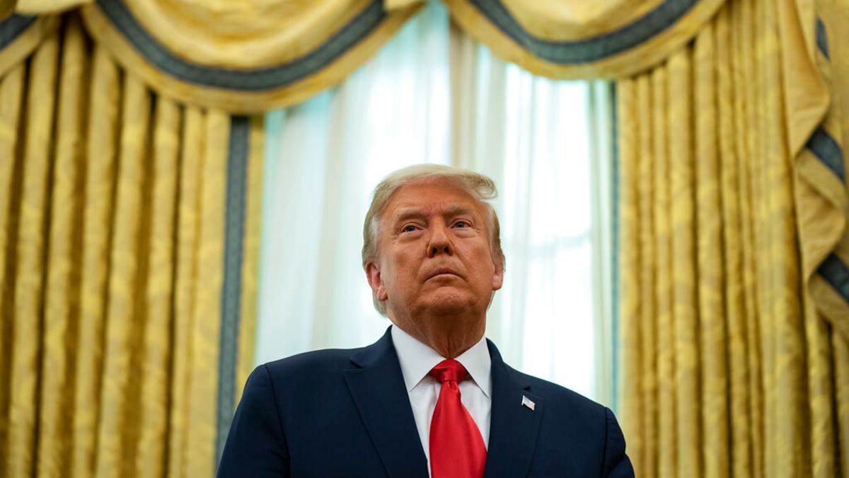 President Donald Trump listens during a ceremony to present the Presidential Medal of Freedom to former football coach Lou Holtz, in the Oval Office of the White House, Dec. 3, in Washington. (AP Photo/Evan Vucci)