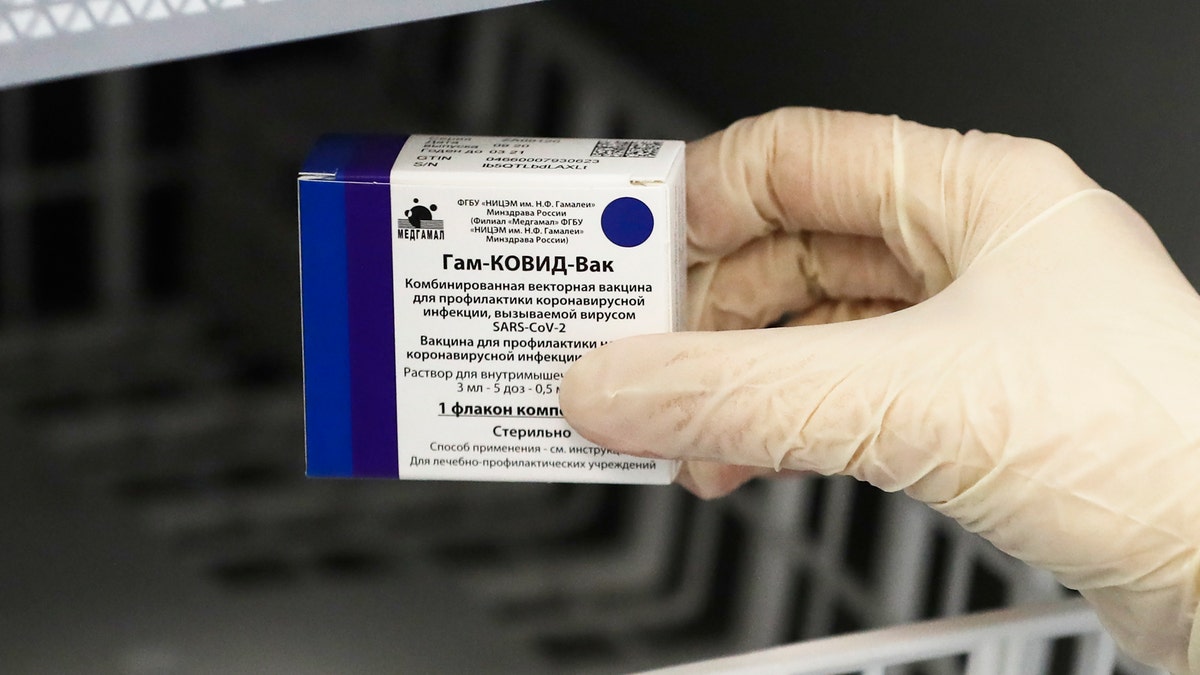 A medical worker moves a box of Russia's Sputnik V coronavirus vaccine out from a refrigerator prior to administering a vaccination in Moscow, Russia, Saturday, Dec. 5, 2020. Thousands of doctors, teachers and others in high-risk groups have signed up for COVID-19 vaccinations in Moscow starting Saturday, a precursor to a sweeping Russia-wide immunization effort. (AP Photo/Pavel Golovkin)