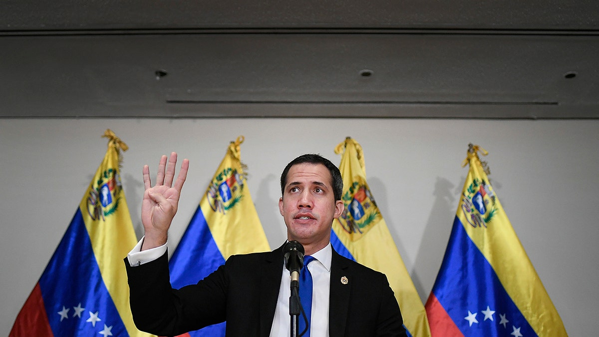 Venezuelan opposition leader Juan Guaido speaks at a press conference in Caracas, Venezuela, Saturday, Dec. 5, 2020, a day before parliamentary elections. Polling places open Sunday to elect members of the National Assembly in a vote championed by President Nicolás Maduro but rejected as a fraud by the nation's most influential opposition politicians. (AP Photo/Matias Delacroix)
