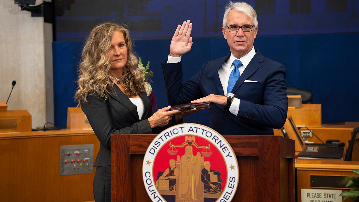 Incoming Los Angeles County District Attorney George Gascon is sworn in as his wife Fabiola Kramsky holds a copy of the Constitution on Dec. 7. (Bryan Chan/County of Los Angeles via AP)