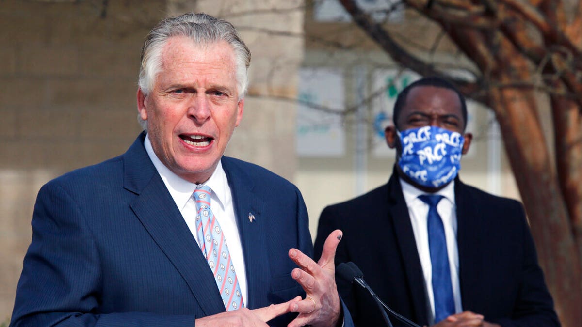 Former Virginia Gov. Terry McAuliffe, left, announces that he is running for the Democratic nomination for governor during a press conference in Richmond, Va., Wednesday, Dec. 9, 2020. (Bob Brown/Richmond Times-Dispatch via AP)