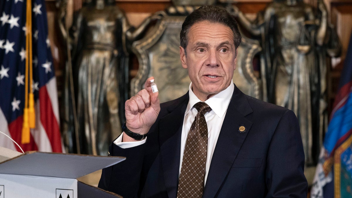 In this Dec. 3, 2020, photo provided by the Office of Gov. Andrew Cuomo, Cuomo holds up samples of empty packaging for the COVID-19 vaccine during a news conference in the Red Room at the State Capitol in Albany, N.Y. (Mike Groll/Office of Governor of Andrew M. Cuomo via AP)