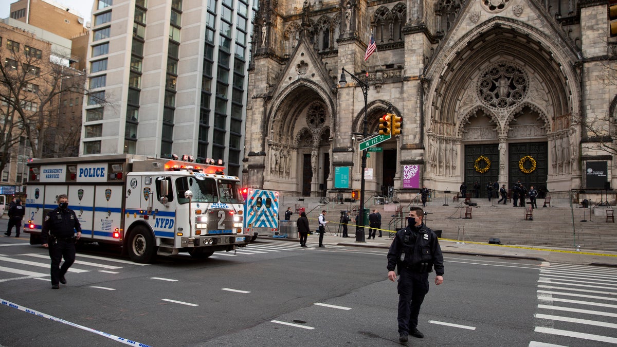 New York police officers block off the scene of a shooting at the Cathedral Church of St. John the Divine, Sunday, Dec. 13, 2020, in New York. (Associated Press)