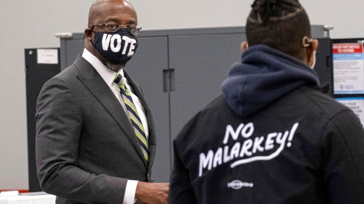 Democrat Georgia Senate challenger Rev. Raphael Warnock arrives to vote at the C.T. Martin Natatorium and Recreation Center in Atlanta on the first day of early voting for the senate runoff Monday, Dec. 14, 2020.