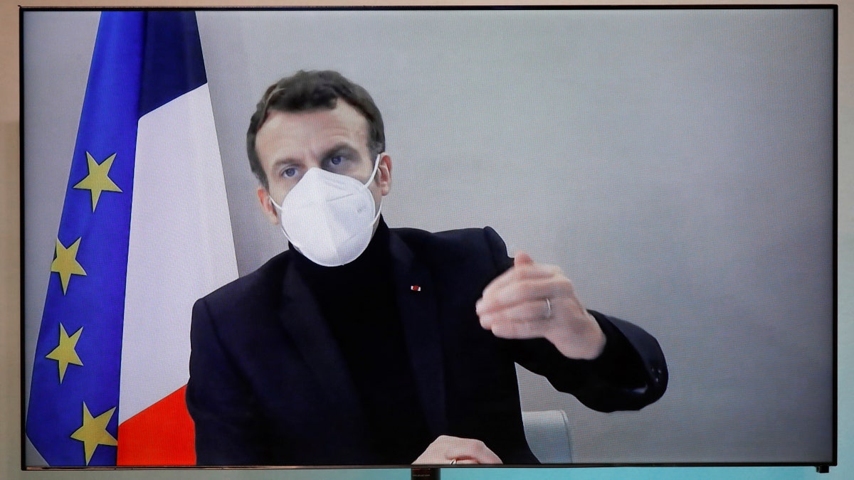 French President Emmanuel Macron is seen on a screen as he attends by video conference a round table for the National Humanitarian Conference (NHC), taken at the Foreign Ministry in Paris,Thursday, Dec. 17, 2020. French President Emmanuel Macron tested positive for COVID-19 Thursday following a week in which he met with numerous European leaders. (Charles Platiau/Pool via AP)