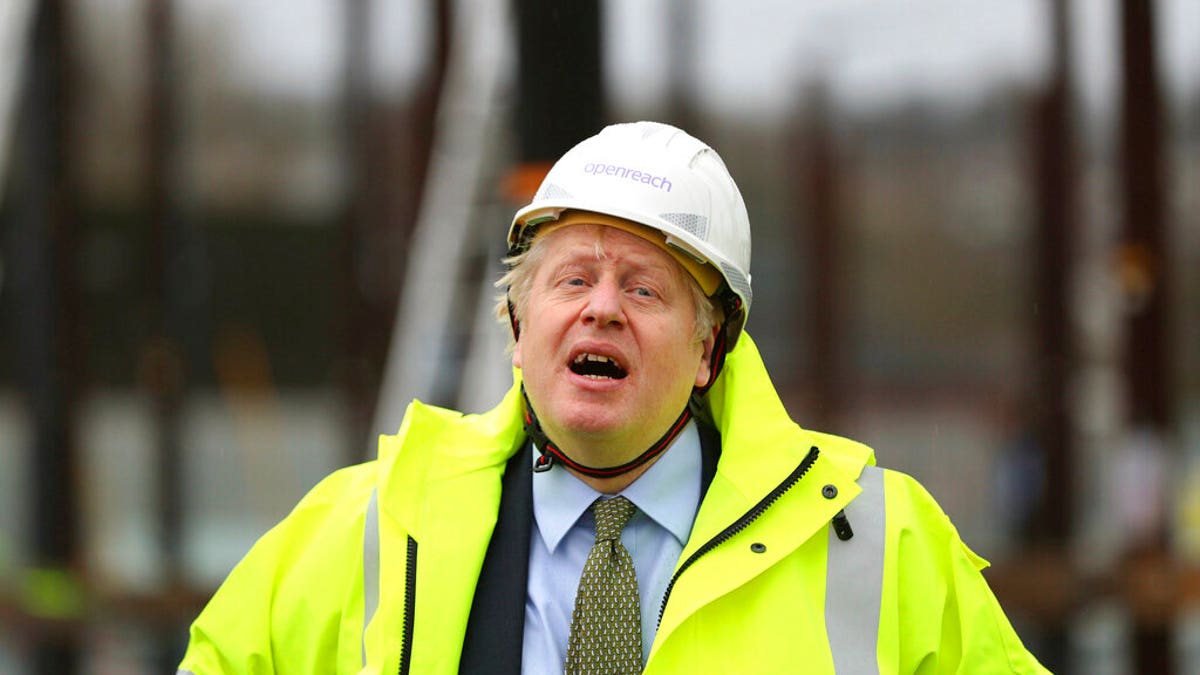 Britain's Prime Minister Boris Johnson reacts, during a visit to the Openreach L and D Training Centre in Bolton, England, Friday, Dec. 18, 2020. 