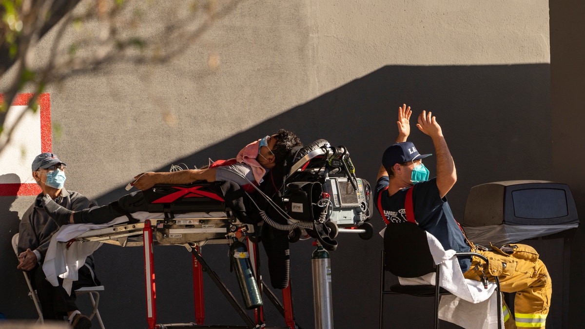 An unidentified patient receives oxygen on a stretcher outside the CHA Hollywood Presbyterian Medical Center in Los Angeles, Dec. 18, 2020. (Associated Press)