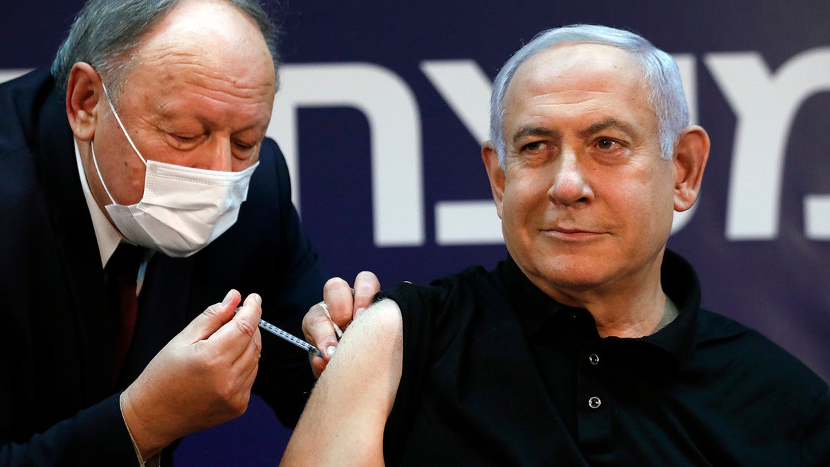Israeli Prime Minister Benjamin Netanyahu receives a coronavirus vaccine at Sheba Medical Center in Ramat Gan, Israel on Saturday, Dec. 19, 2020. (Amir Cohen/Pool via AP)