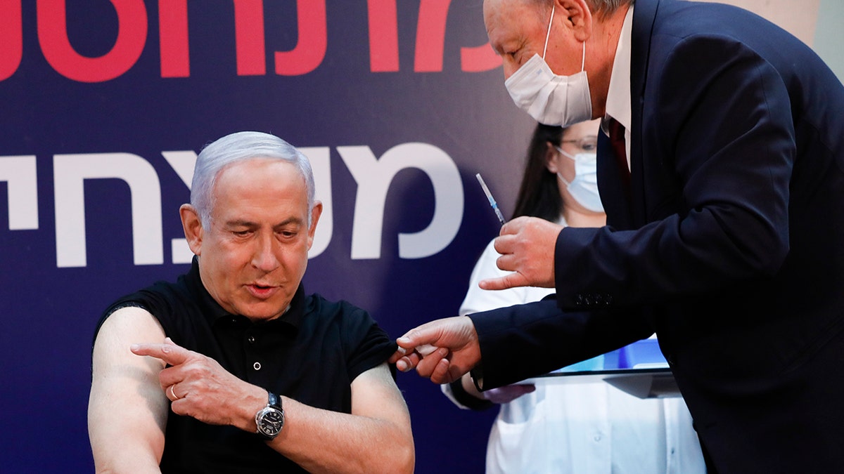 Israeli Prime Minister Benjamin Netanyahu receives a coronavirus vaccine at Sheba Medical Center in Ramat Gan, Israel on Saturday, Dec. 19, 2020. (Amir Cohen/Pool via AP)