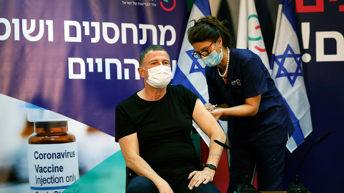 Israeli Health Minister Yuli Edelstein receives a coronavirus vaccine at Sheba Medical Center in Ramat Gan, Israel on Saturday, Dec. 19, 2020. (Amir Cohen/Pool via AP)