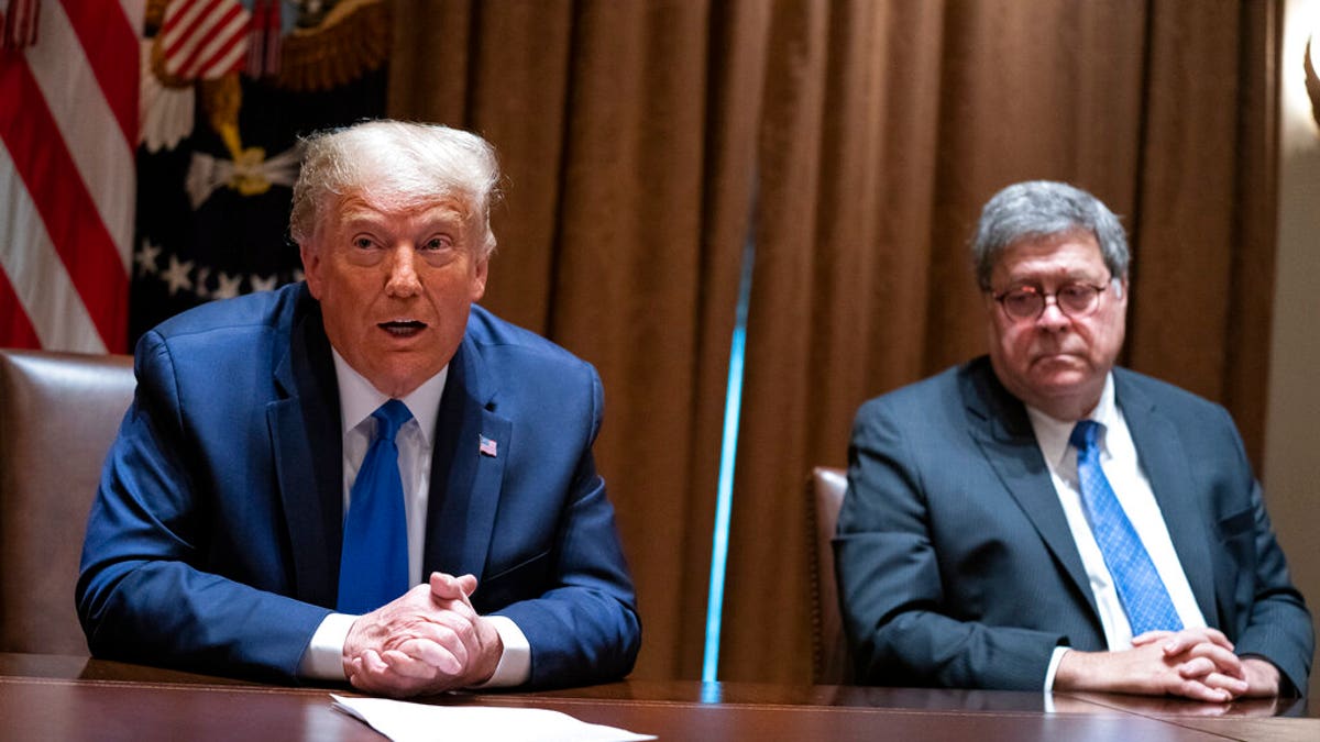 FILE - In this Sept. 23, 2020, file photo Attorney General William Barr listens as President Donald Trump speaks during a meeting with Republican state attorneys general about social media companies, in the Cabinet Room of the White House in Washington. (AP Photo/Evan Vucci, File)
