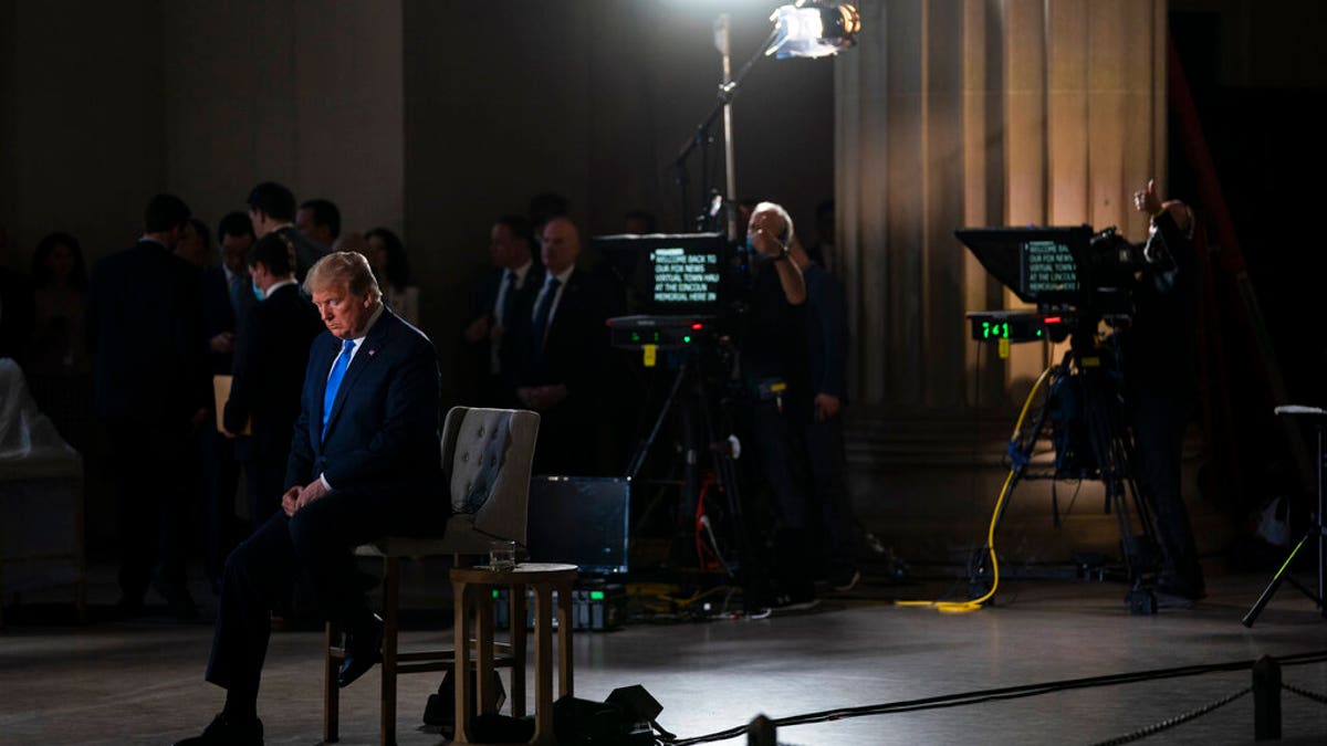 FILE: President Donald Trump waits for a segment to start during a Fox News virtual town hall from the Lincoln Memorial in Washington.