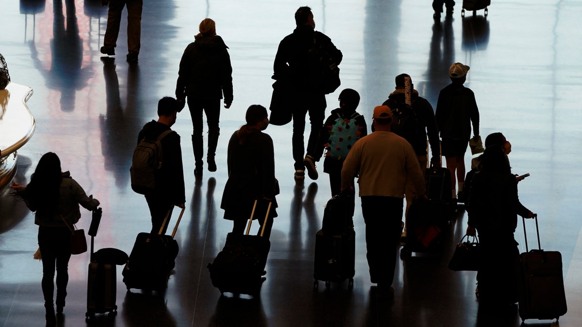 ​​​​​Travelers walk through Salt Lake City International Airport in Salt Lake City. (AP Photo/Rick Bowmer, File)