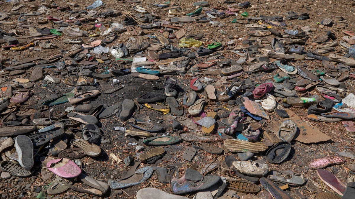 Shoes left behind belonging to Tigrayan refugees are scattered near the banks of the Tekeze River on the Sudan-Ethiopia border after Ethiopian forces blocked people from crossing into Sudan, in Hamdayet, eastern Sudan, Dec. 15. 