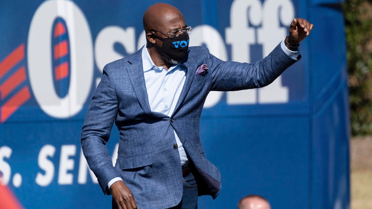 Democratic U.S. Senate challenger the Rev. Raphael Warnock during a rally Monday, Dec. 21, 2020, in Columbus, Ga., with Vice President-Elect Kamala Harris and fellow Democratic U.S. Senate challenger Jon Ossoff. (AP Photo/Ben Gray)