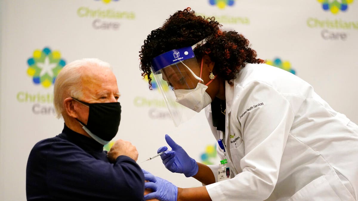 President-elect Joe Biden receives his first dose of the coronavirus vaccine at ChristianaCare Christiana Hospital in Newark, Del., Monday, Dec. 21, 2020, from nurse practitioner Tabe Mase. (AP Photo/Carolyn Kaster)
