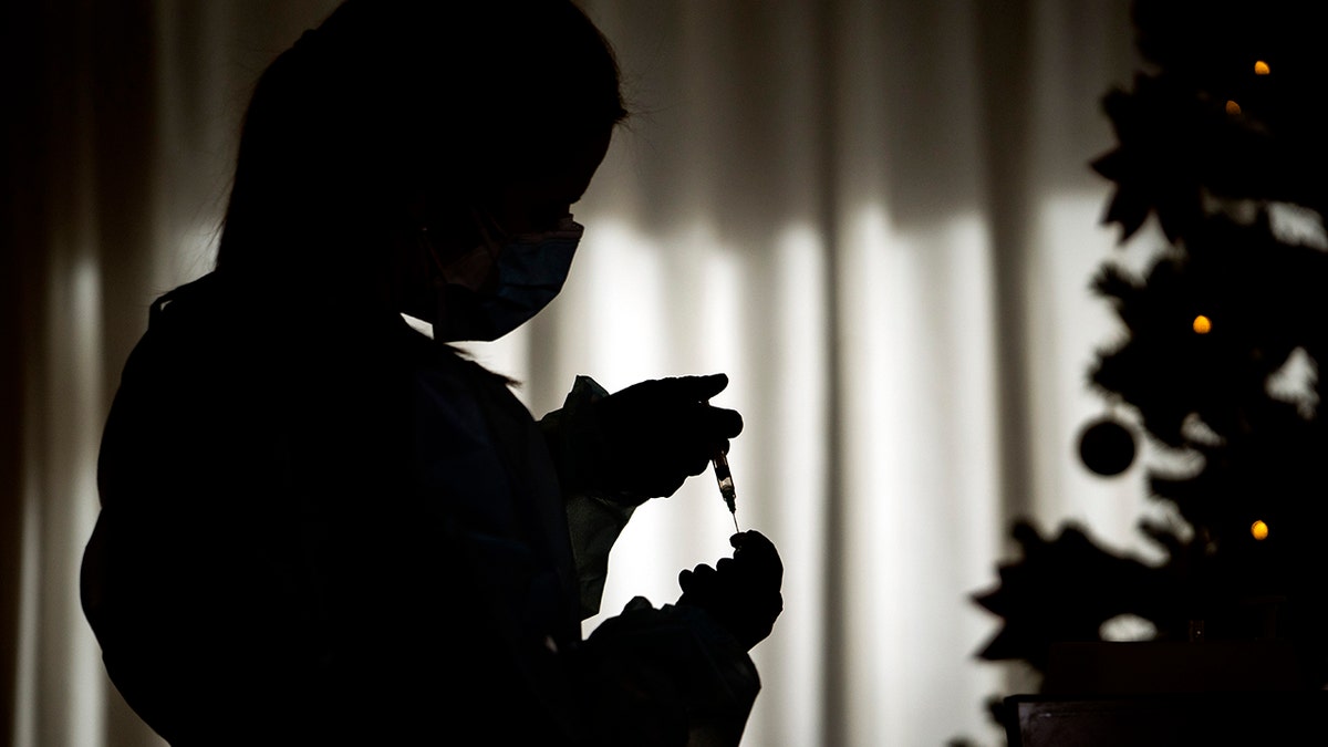 Nurse Idoia Crespo prepares a vaccine against the Coronavirus at a nursing home in l'Hospitalet de Llobregat in Barcelona, Spain, on Sunday, Dec. 27, 2020. The first shipments of coronavirus vaccines developed by BioNTech and Pfizer have arrived across the European Union, authorities started to vaccinate the most vulnerable people in a coordinated effort on Sunday. (AP Photo/Emilio Morenatti)