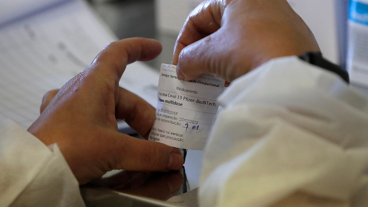 A nurse prepares a dose of the Pfizer-BioNTech COVID-19 vaccine at the Santa Maria hospital in Lisbon, Sunday, Dec. 27, 2020. Portugal started its vaccination program on Sunday with medical personnel in reference hospitals across the country receiving the first shots. (AP Photo/Armando Franca)