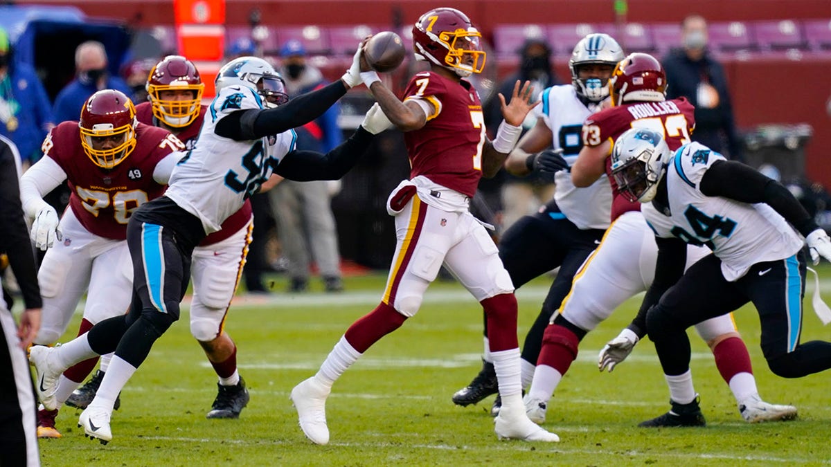 Carolina Panthers defensive end Marquis Haynes (98) puts his hand on the ball as Washington Football Team quarterback Dwayne Haskins (7) passes during the first half of an NFL football game, Sunday, Dec. 27, 2020, in Landover, Md. (AP Photo/Carolyn Kaster)